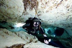 Diver in cave with 2 slave strobes by Becky Kagan 